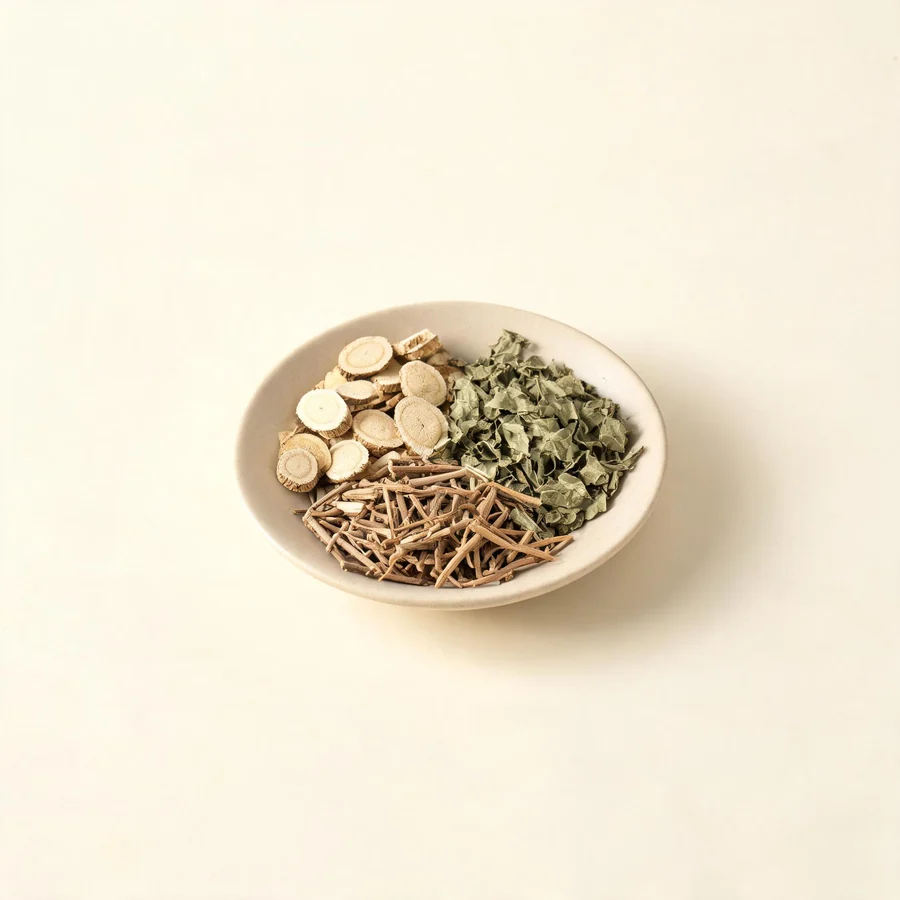 An editorial still life of the traditional Chinese herbs used for this condition, arranged on a warm off-white surface: pale root slices.