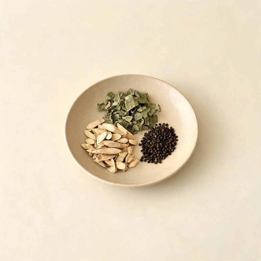 An editorial still life of the traditional Chinese herbs used for this condition, arranged on a warm off-white surface: pale root slices.