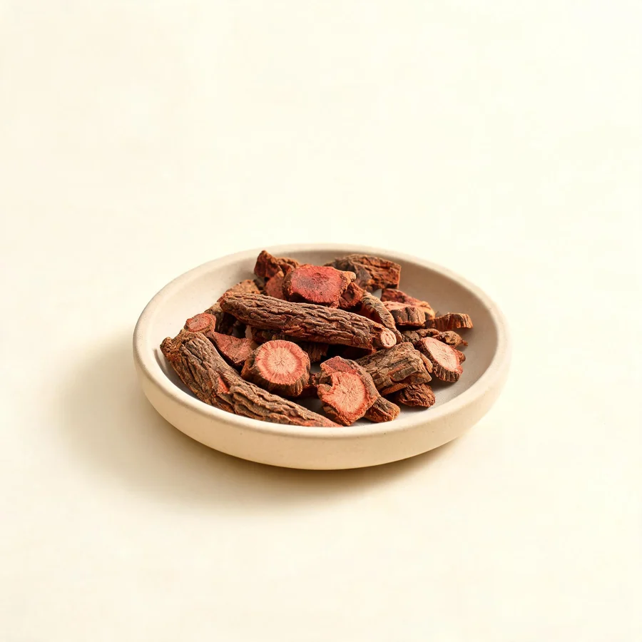 Dried Dan Shen root and rhizome arranged in a shallow bowl