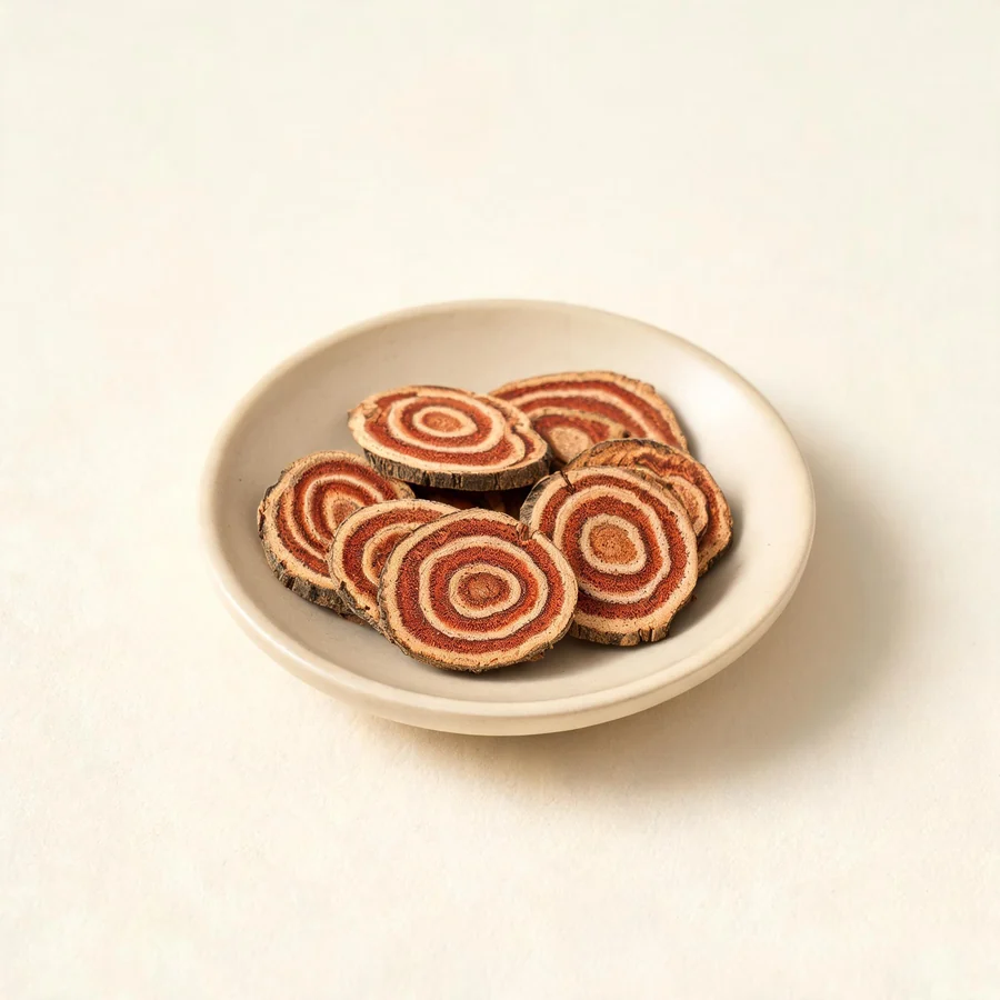 Dried Ji Xue Teng stem arranged in a shallow bowl