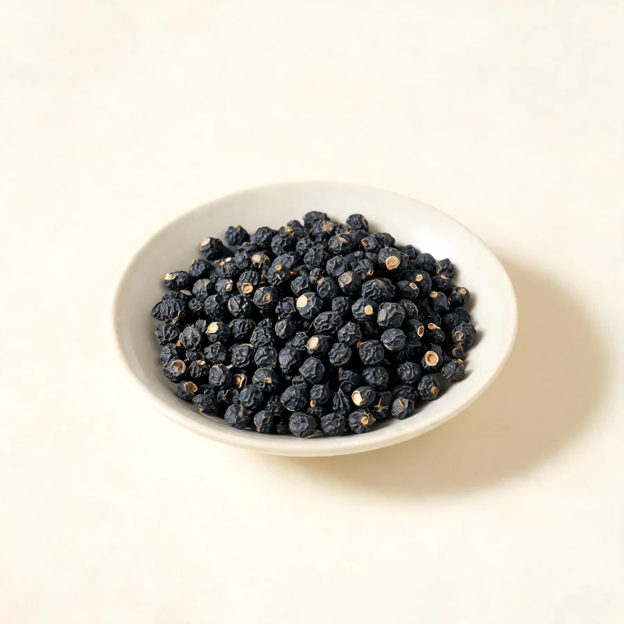 Dried Nu Zhen Zi fruit arranged in a shallow bowl