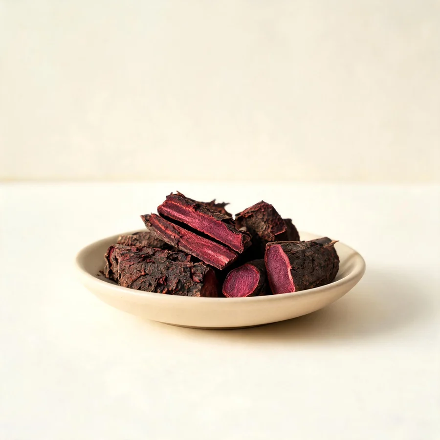 Dried Zi Cao root arranged in a shallow bowl